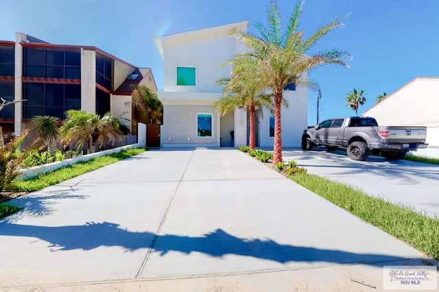 contemporary home with stucco siding and driveway