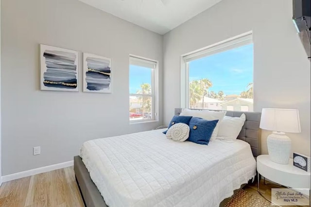 bedroom featuring baseboards and light wood-type flooring
