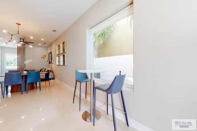 dining room featuring baseboards and a chandelier