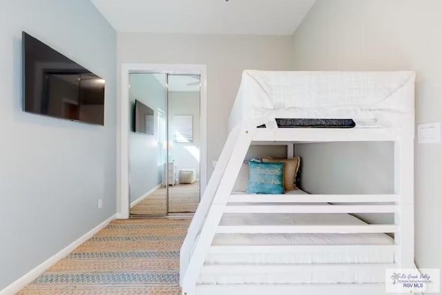 staircase featuring baseboards and carpet