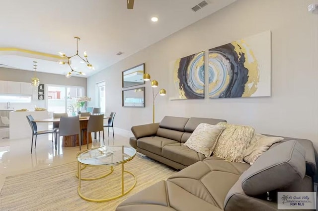 living area featuring visible vents, recessed lighting, baseboards, and a chandelier