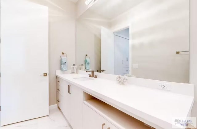 bathroom featuring vanity and marble finish floor
