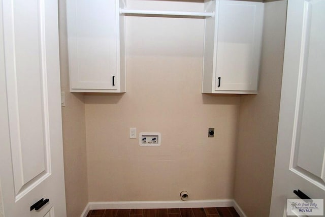 clothes washing area with cabinets, hookup for a washing machine, hookup for an electric dryer, and dark hardwood / wood-style flooring