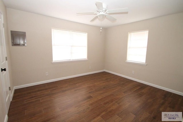 spare room with a healthy amount of sunlight, dark wood-type flooring, and ceiling fan