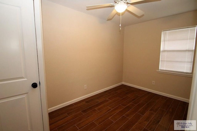 empty room featuring ceiling fan and dark hardwood / wood-style flooring