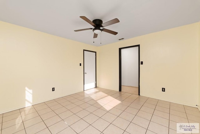 spare room featuring ceiling fan and light tile patterned flooring