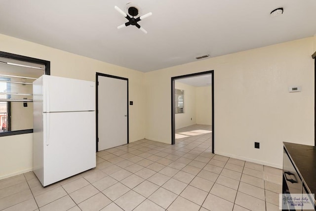 unfurnished room with light tile patterned floors