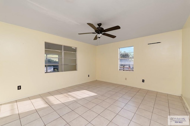 spare room featuring ceiling fan and light tile patterned floors