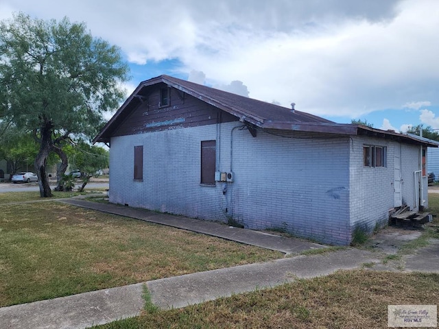 view of home's exterior with a yard