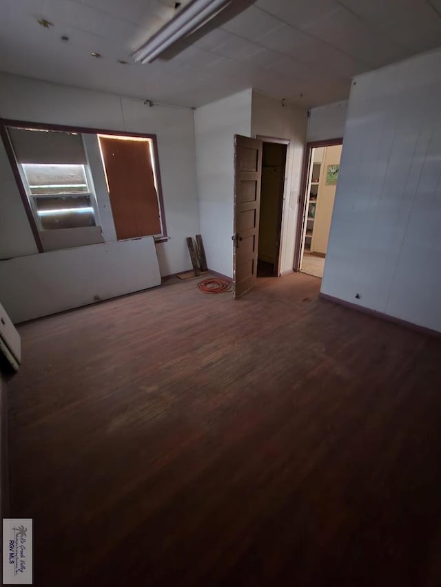 unfurnished room with wood-type flooring