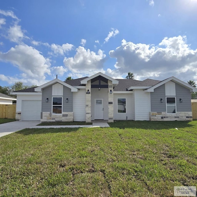 single story home featuring a garage and a front yard