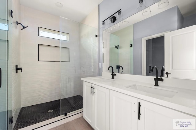 bathroom featuring vanity and an enclosed shower