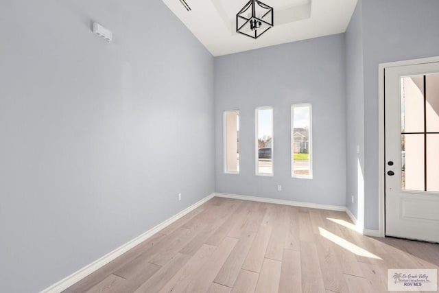 entrance foyer featuring a notable chandelier and light hardwood / wood-style flooring