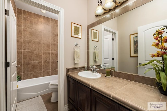 bathroom with vanity, toilet, and bathing tub / shower combination