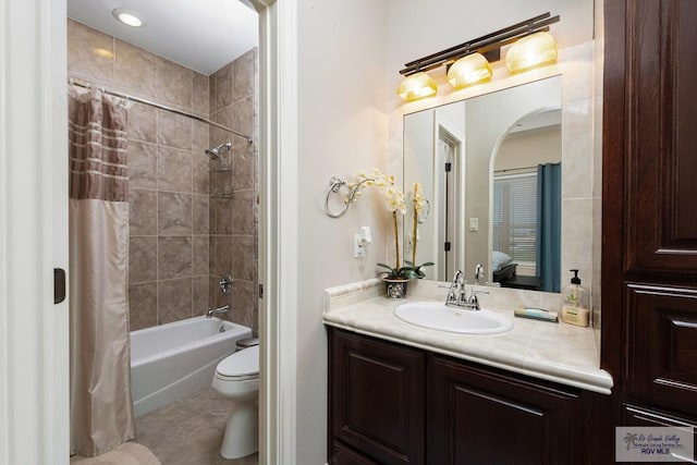 bathroom featuring toilet, tile patterned flooring, shower / bath combination with curtain, and vanity