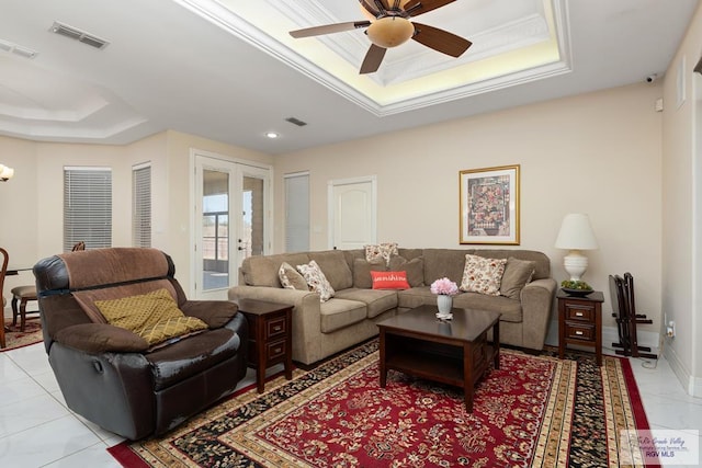 living room featuring ornamental molding, french doors, a raised ceiling, and visible vents