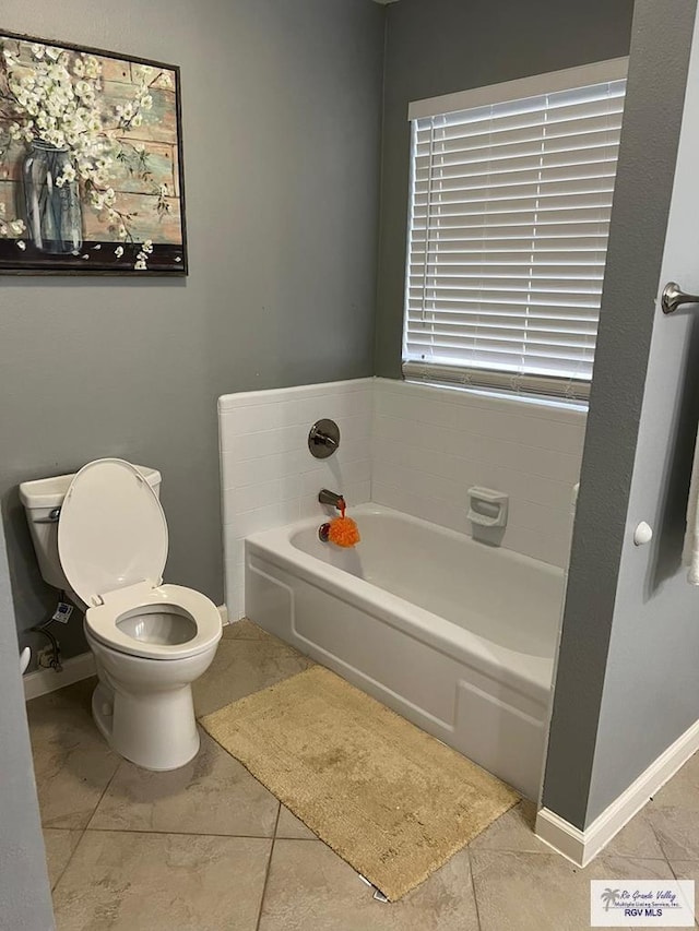 bathroom with a bath and toilet