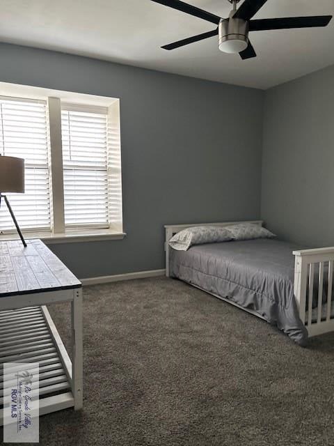 bedroom featuring ceiling fan and dark carpet