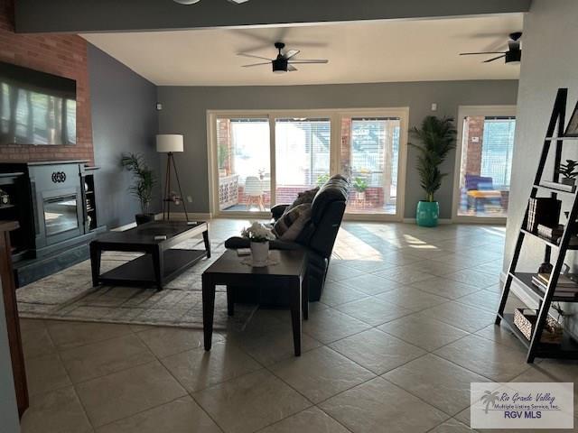 tiled living room with ceiling fan