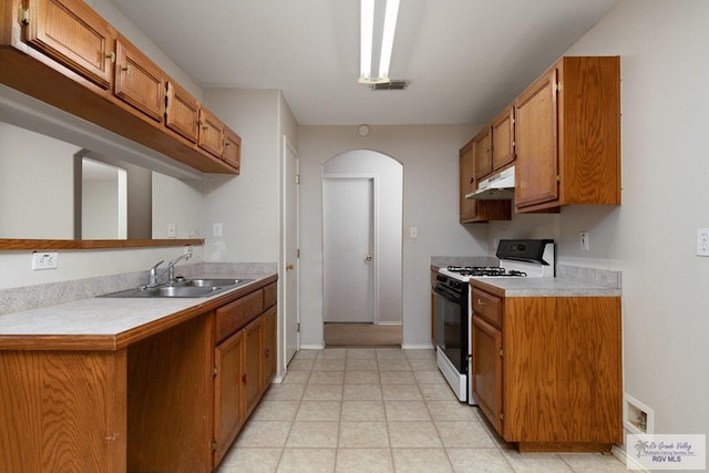 kitchen with sink and gas range oven