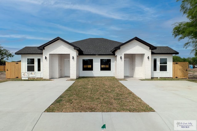 view of front of property with a front yard and a garage