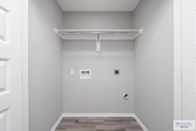 laundry area featuring electric dryer hookup, hookup for a washing machine, and wood-type flooring