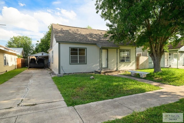 718 Pierce Ave, Harlingen, TX 78550 - view of front of home featuring roof with shingles, driveway, and entry steps