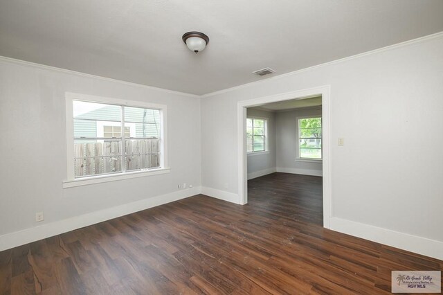 718 Pierce Ave, Harlingen, TX 78550 - unfurnished room featuring ornamental molding and dark wood-style floors