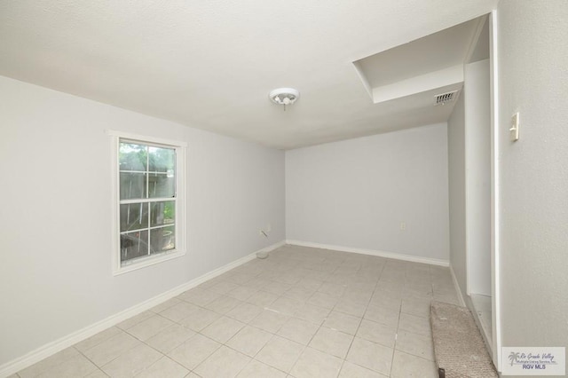 718 Pierce Ave, Harlingen, TX 78550 - empty room featuring light tile patterned floors and baseboards
