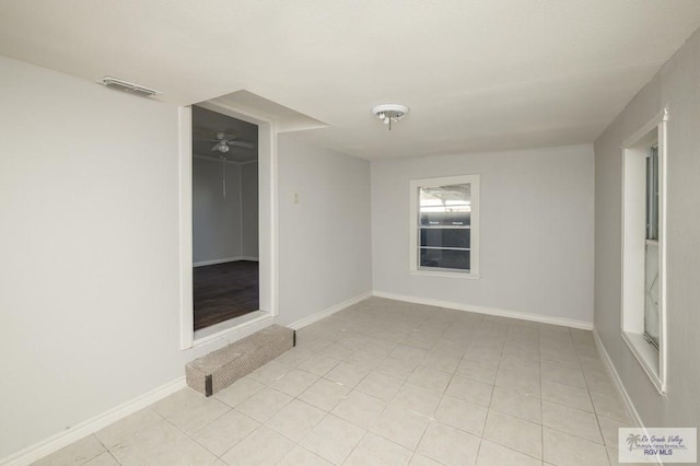 718 Pierce Ave, Harlingen, TX 78550 - spare room featuring light tile patterned floors and baseboards