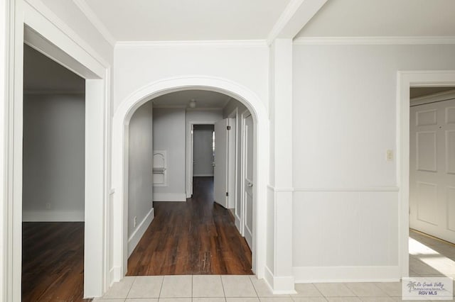 718 Pierce Ave, Harlingen, TX 78550 - hallway featuring arched walkways, wood finished floors, ornamental molding, and a wainscoted wall