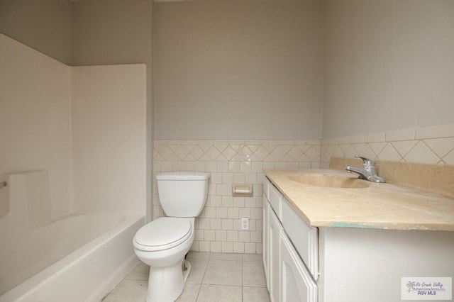 718 Pierce Ave, Harlingen, TX 78550 - full bathroom featuring tile patterned flooring, vanity, tile walls, wainscoting, and shower / bathtub combination