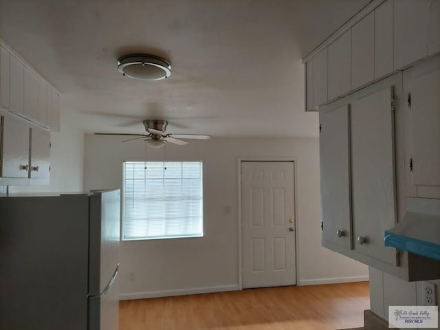 kitchen featuring light hardwood / wood-style flooring, fridge, and ceiling fan