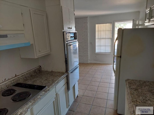 kitchen with stainless steel oven, exhaust hood, white cabinets, electric cooktop, and white fridge