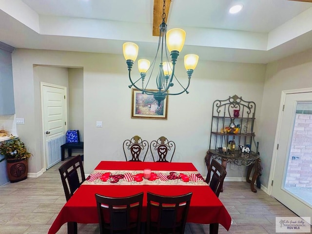 dining room featuring a chandelier and light hardwood / wood-style flooring