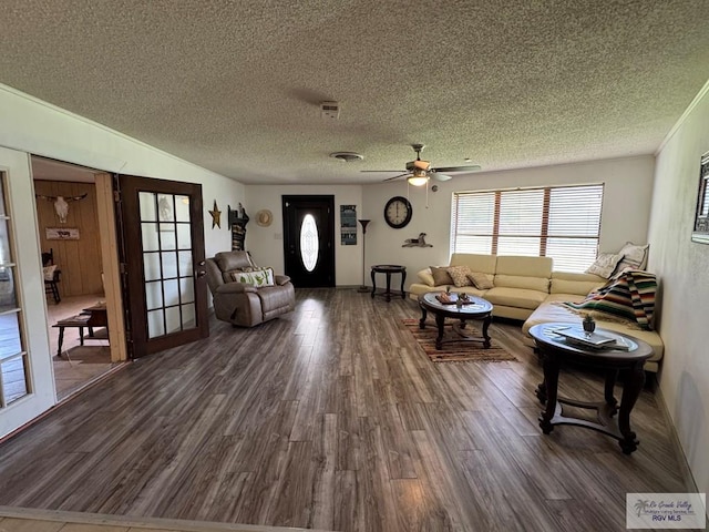 living room featuring a ceiling fan, a textured ceiling, and wood finished floors