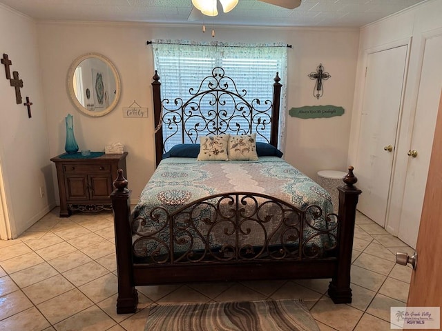 bedroom with light tile patterned flooring, a ceiling fan, and ornamental molding