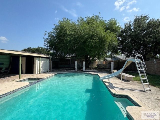 view of swimming pool featuring a fenced backyard, a fenced in pool, a water slide, and a patio area