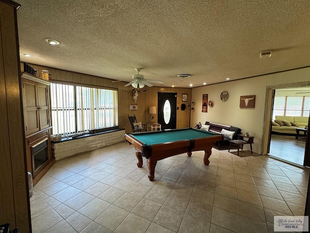 recreation room featuring pool table, a textured ceiling, and a wealth of natural light