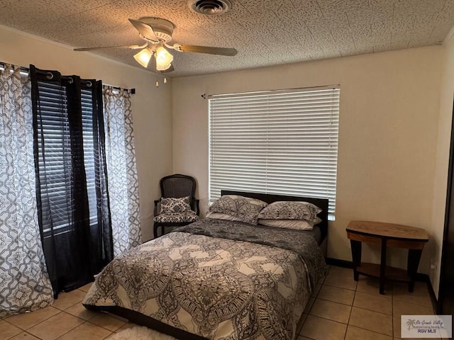 bedroom featuring visible vents, a ceiling fan, and light tile patterned flooring