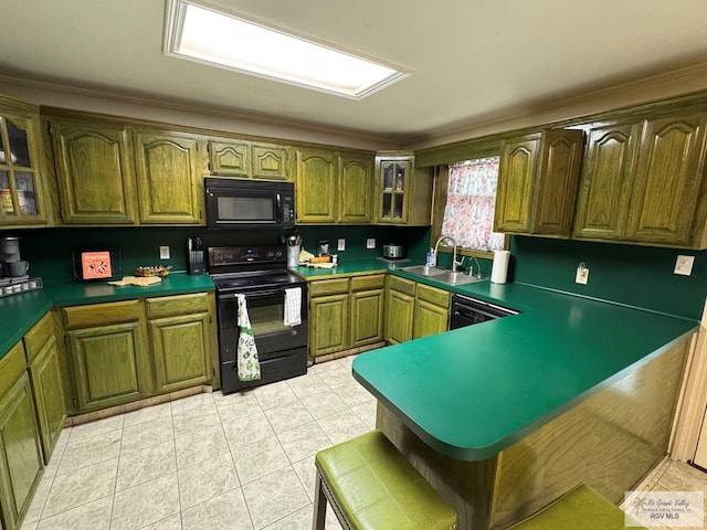 kitchen featuring a sink, black appliances, a peninsula, glass insert cabinets, and light tile patterned flooring