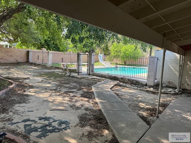 exterior space featuring fence and a fenced in pool
