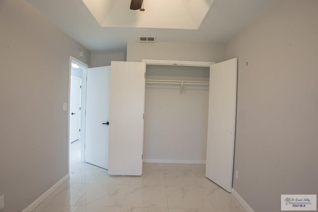 7549 Laurel Ave, Brownsville, TX 78526 - unfurnished bedroom featuring light marble finish floors, a closet, and ceiling fan