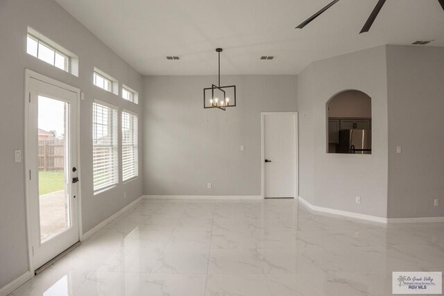 7549 Laurel Ave, Brownsville, TX 78526 - unfurnished dining area with light marble finish floors, arched walkways, a chandelier, and ceiling fan