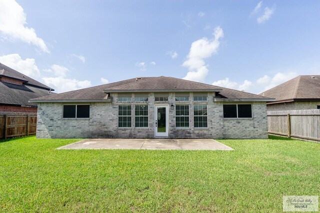 7549 Laurel Ave, Brownsville, TX 78526 - rear view of house featuring a patio area, a fenced backyard, and brick siding