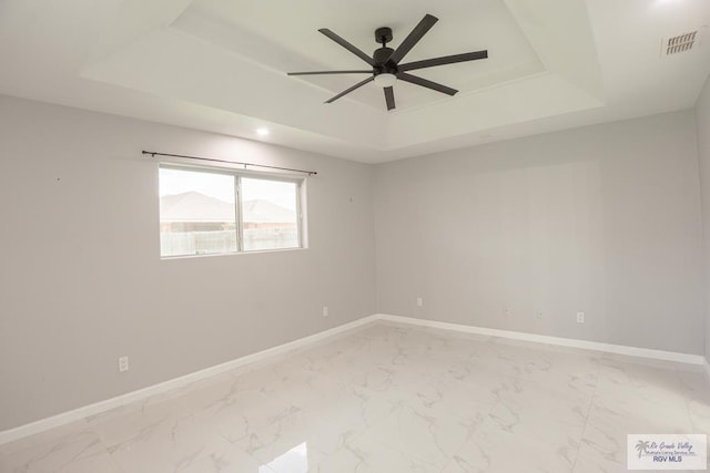 7549 Laurel Ave, Brownsville, TX 78526 - spare room with a tray ceiling, ceiling fan, light marble finish flooring, and recessed lighting