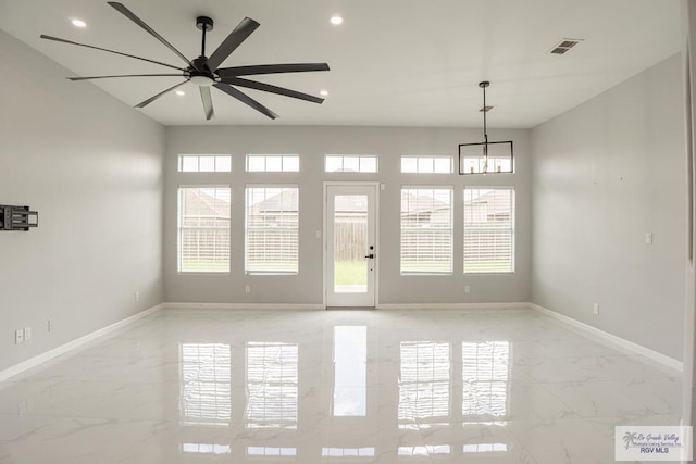 7549 Laurel Ave, Brownsville, TX 78526 - unfurnished room featuring light marble finish floors, a ceiling fan, recessed lighting, and a chandelier