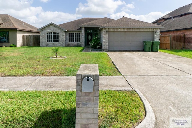 7549 Laurel Ave, Brownsville, TX 78526 - ranch-style house featuring a garage, driveway, stone siding, and a shingled roof