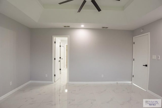 7549 Laurel Ave, Brownsville, TX 78526 - unfurnished room featuring marble finish flooring, ceiling fan, a raised ceiling, and recessed lighting