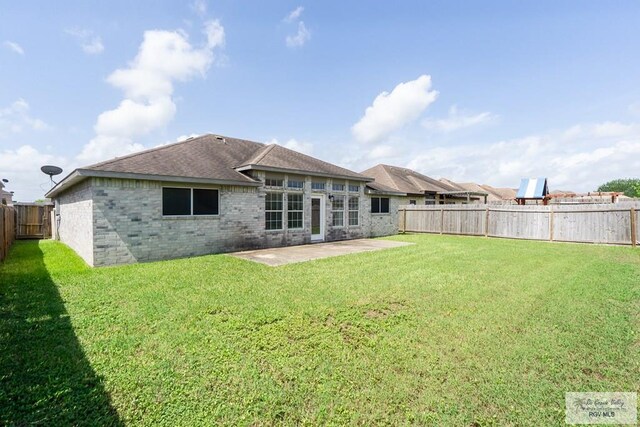 7549 Laurel Ave, Brownsville, TX 78526 - back of house featuring a patio area, a fenced backyard, brick siding, and roof with shingles